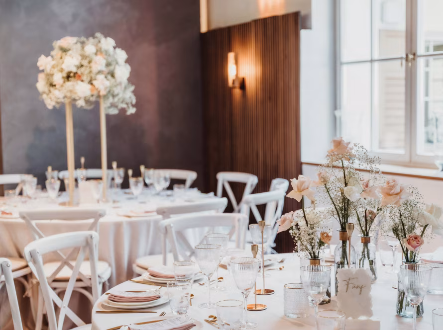 luxury event planning portfolio Elegant venue with floral arrangements and table setup for a luxury event.