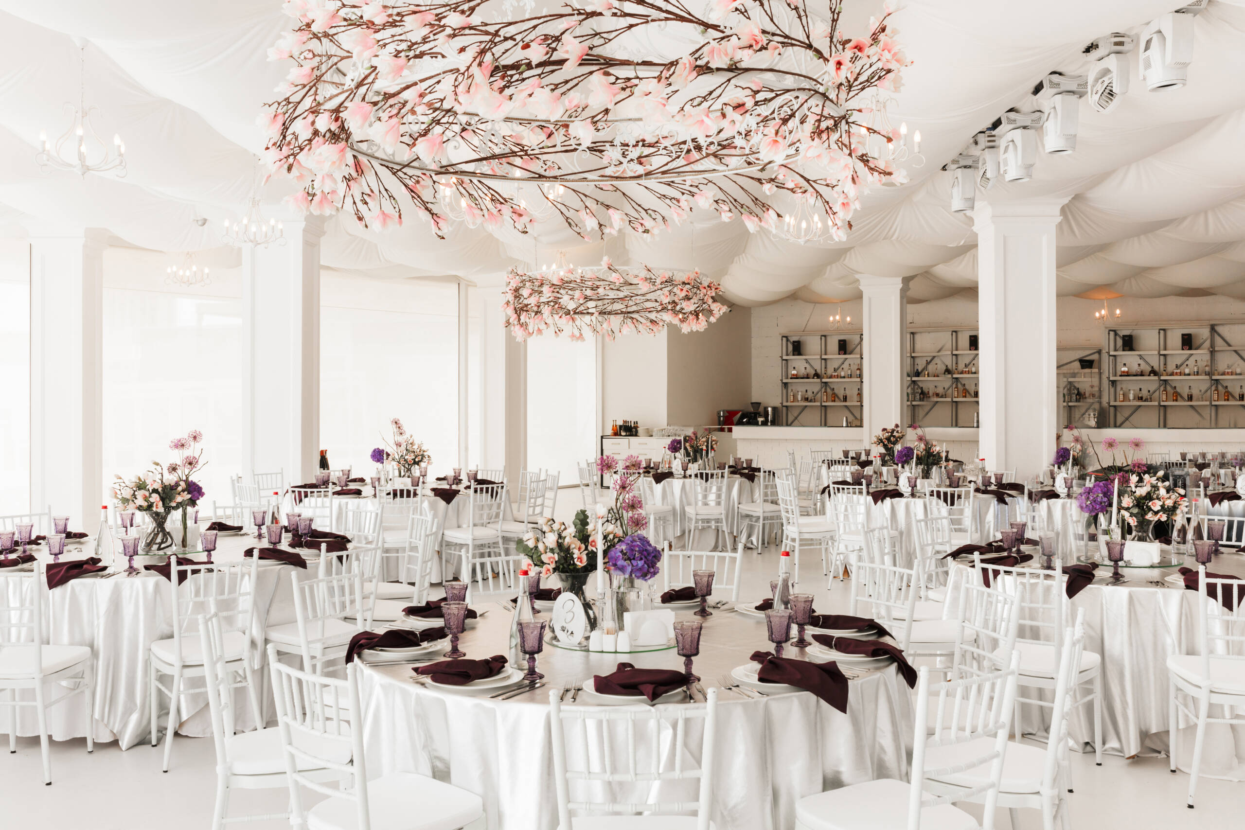 Photo of beautiful white wedding hall with big tables isolated
