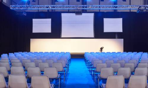 Conference room with video projectors, screens and platform. Professional presentation