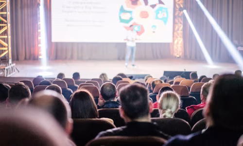 Luxury corporate event with audience and stage presentation.